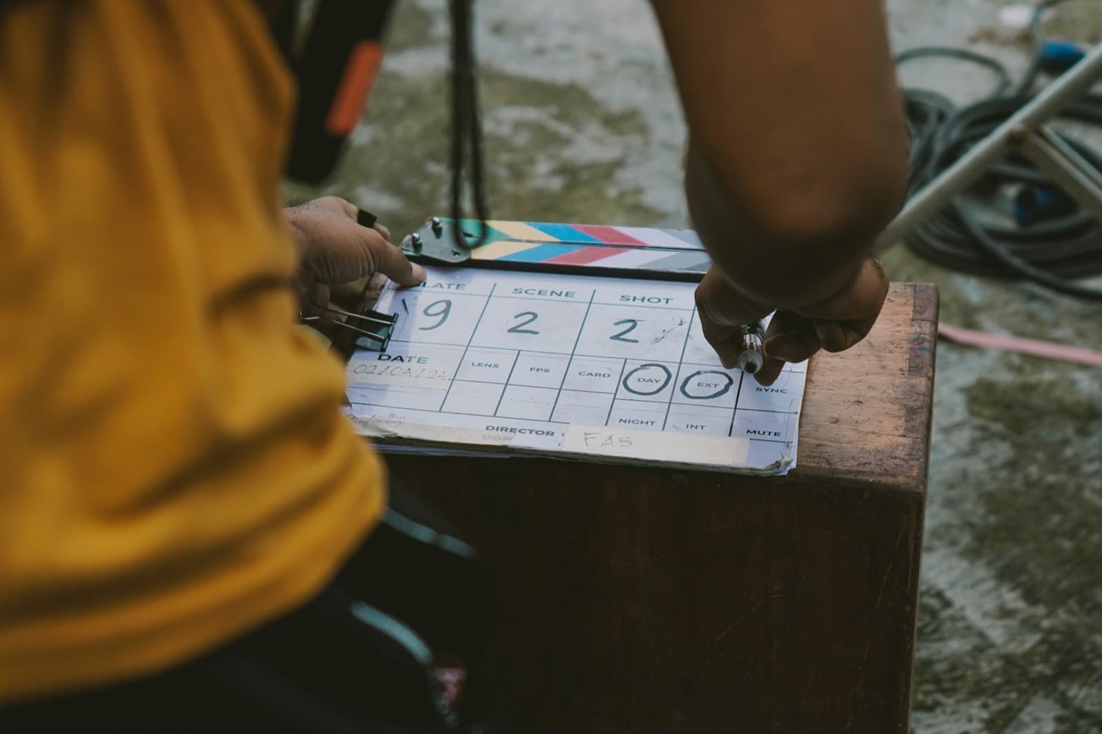 a hand writing on a slate with a marker